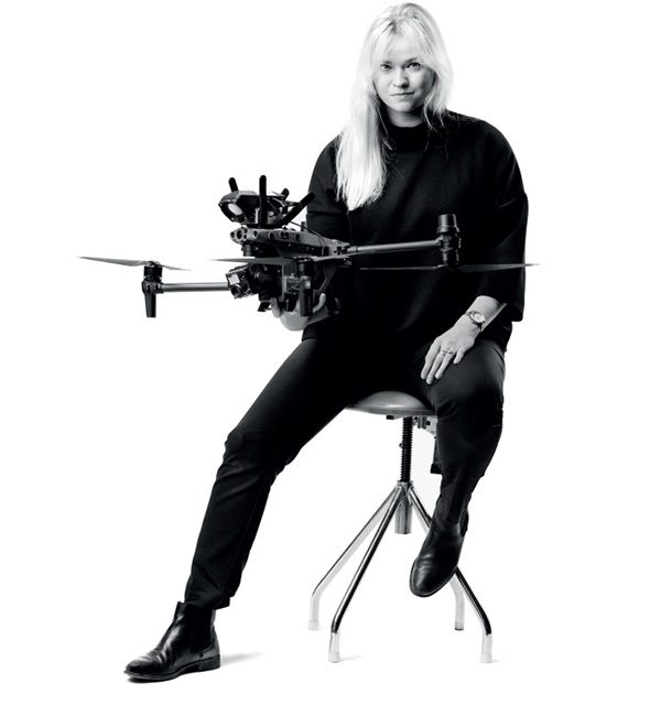 A black and white picture of FLOX CEO Sara holding a drone.