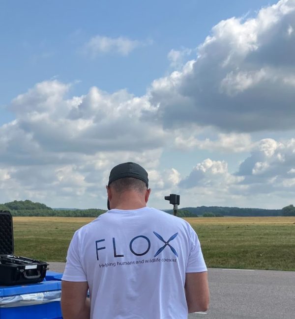 FLOX robotics team out in field flying drone.